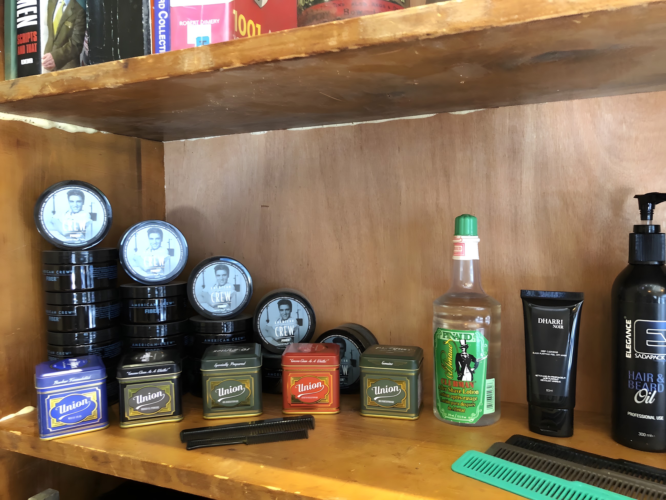 Pomades, aftershave and grooming products on the shop shelf